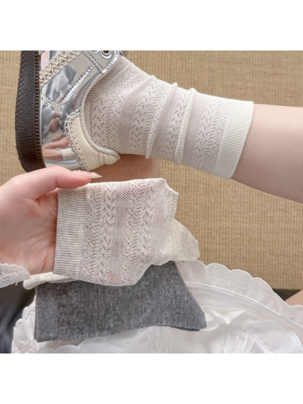 Pair of Rufia neutral textured crew socks laid flat showing full length and texture