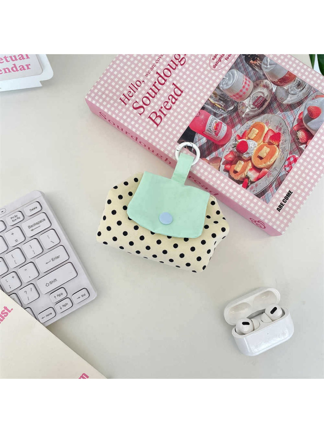 Side view of Cosbai mini polka dot pouch bag highlighting slim profile