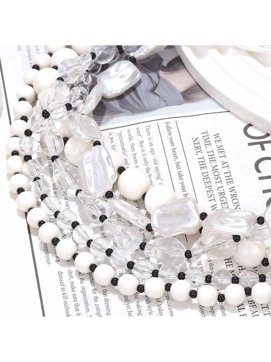 Neckit layered bead necklace with crystal detail shown coiled on a flat surface