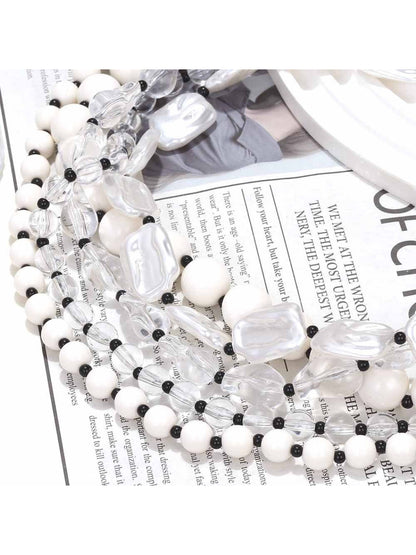 Neckit layered bead necklace with crystal detail shown coiled on a flat surface