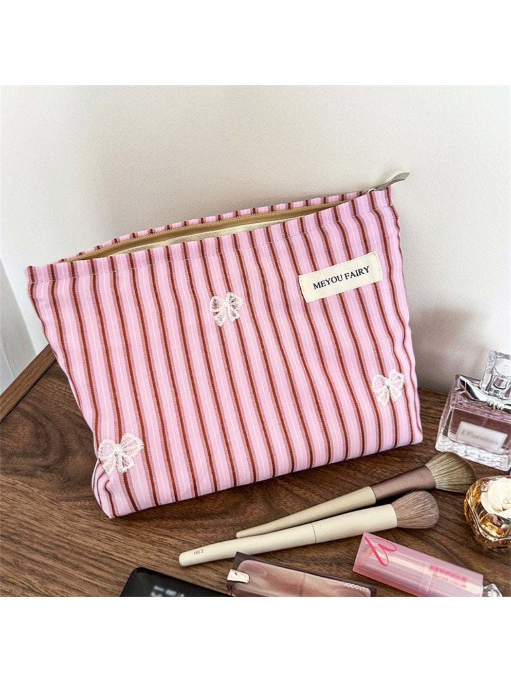 Inside view of pink stripe butterfly makeup bag showing spacious interior