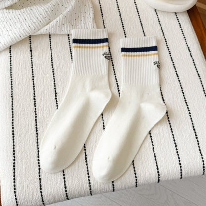 Rufia Retro Stripe Letter Crew Socks worn on feet, displaying fit and stripe design