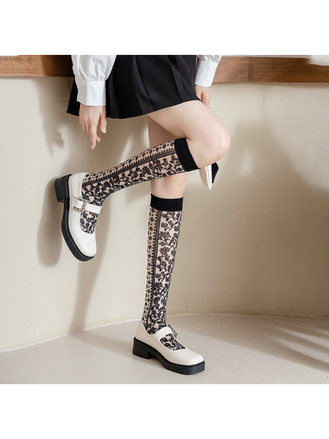 Side view of Rufia knee high sock showing intricate floral lace pattern
