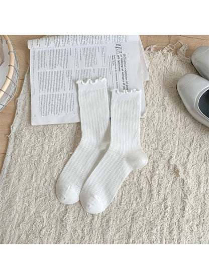 Model wearing Rufia soft frill trim crew socks styled with casual shoes