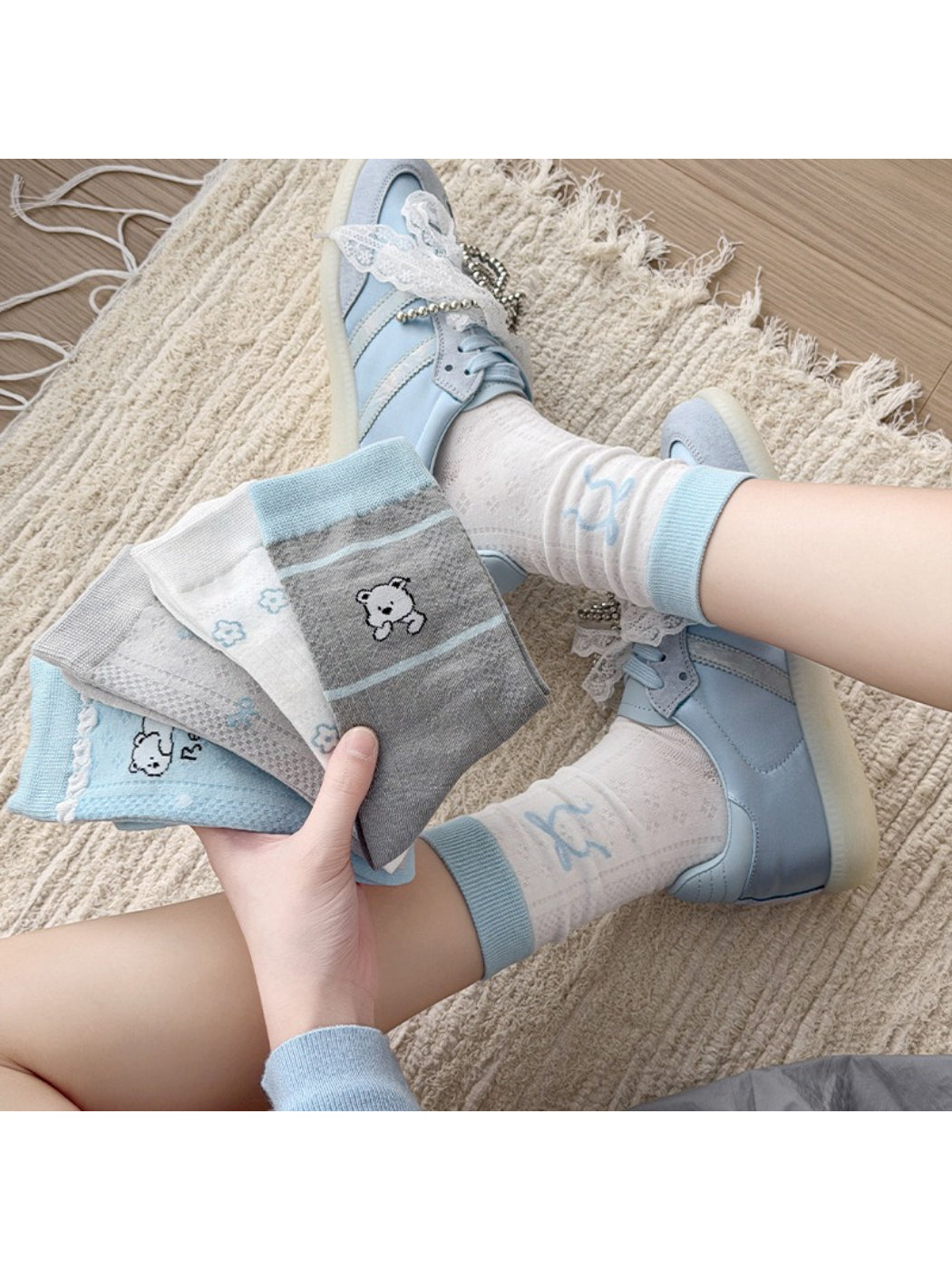 Pair of Rufia cute crew socks with blue accents laid flat on white background