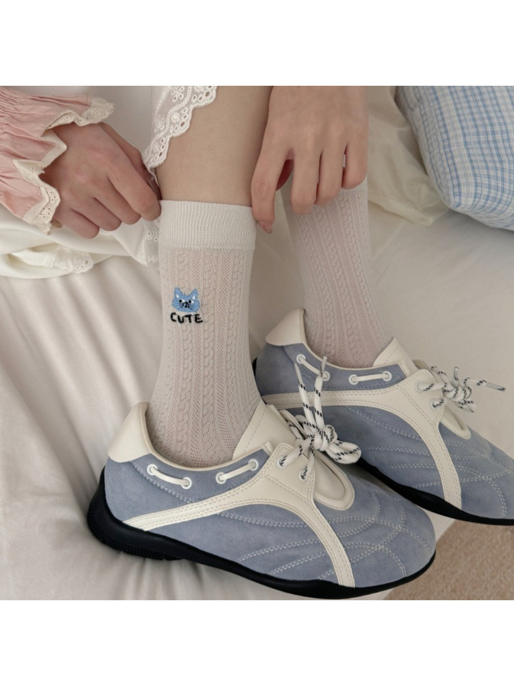 Close-up of Rufia cat knit pattern on soft crew sock fabric