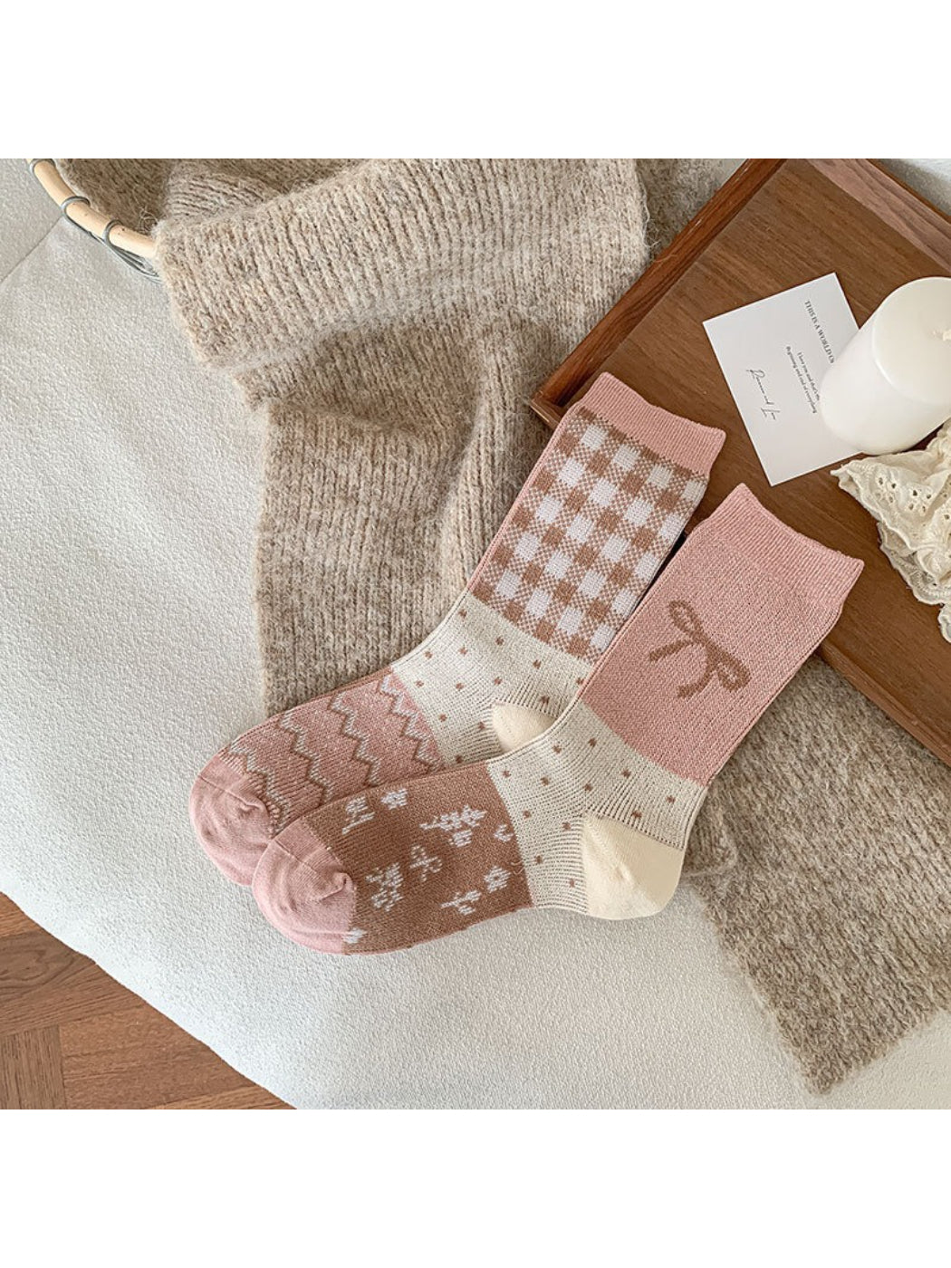 Pair of Rufia socks displayed on wooden surface showing bow and ribbing