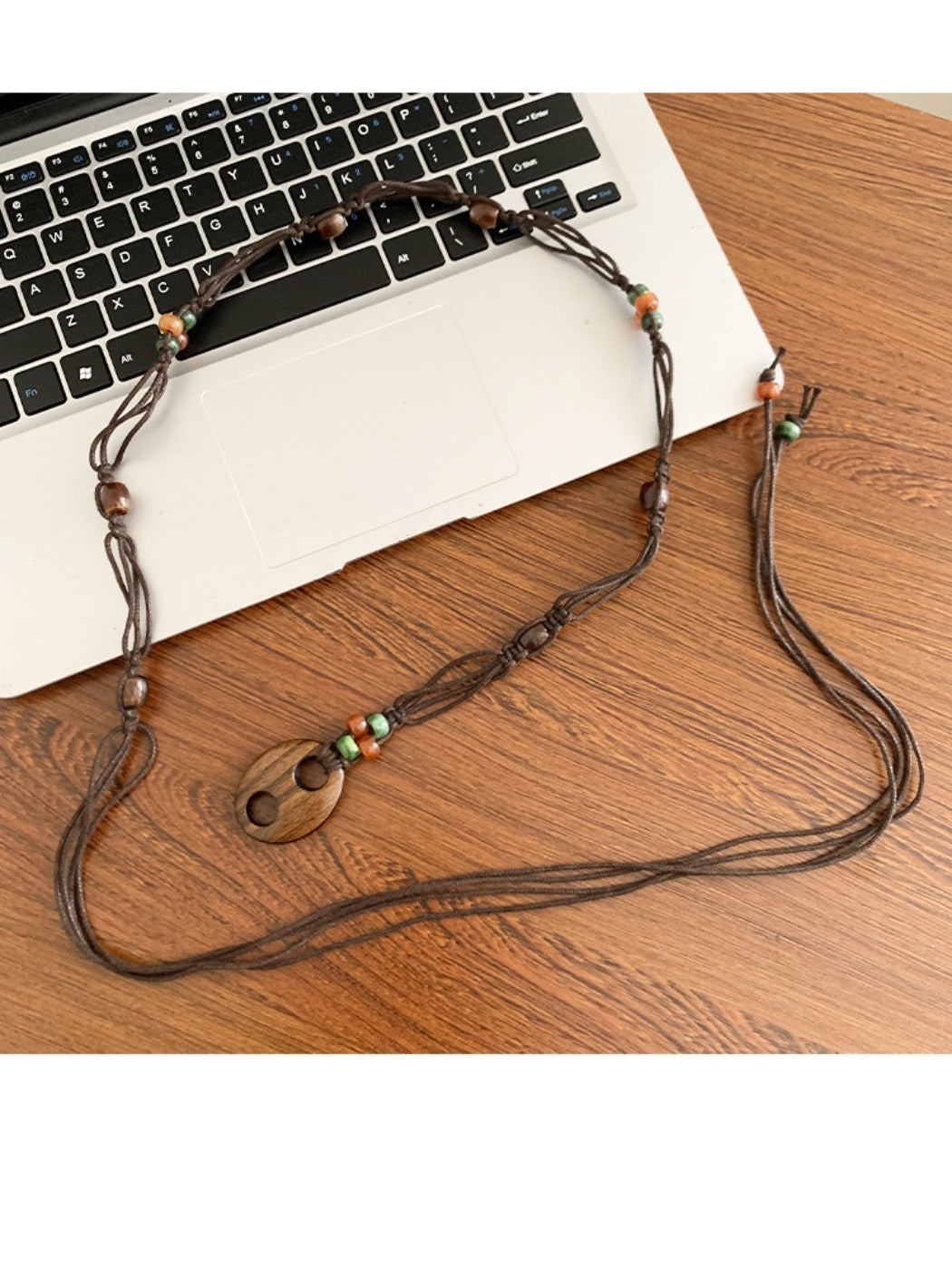 Slim beaded tie waist belt in neutral tones displayed flat on white background