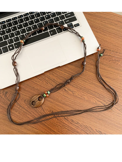 Slim beaded tie waist belt in neutral tones displayed flat on white background