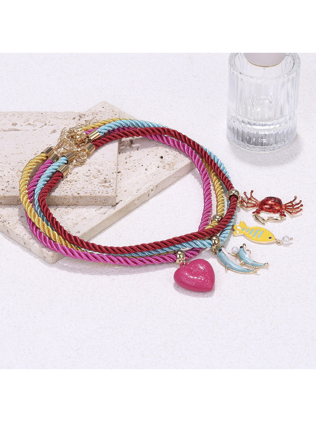 Close-up of colorful rope necklace with ocean charms showing detailed charm designs