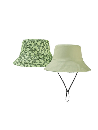 Model wearing Haila reversible flower print hat outdoors