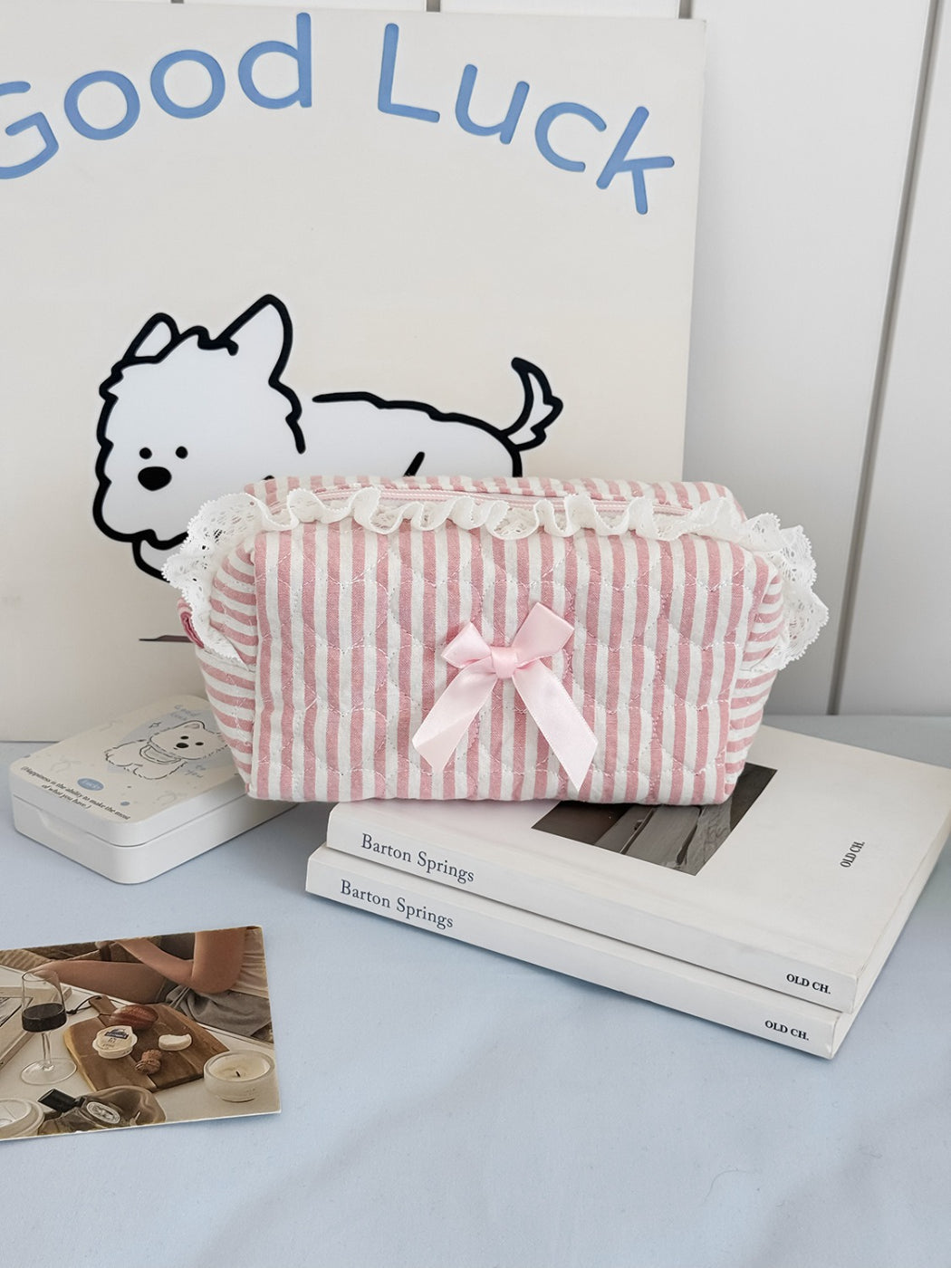 Cosbai cosmetic pouch open with makeup brushes and products inside