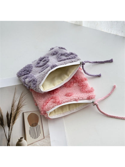 Close-up of the plush red heart gift pouch showing soft fabric texture