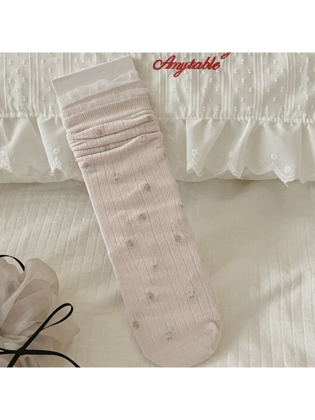 Side view of Rufia ribbed crew socks highlighting bow details