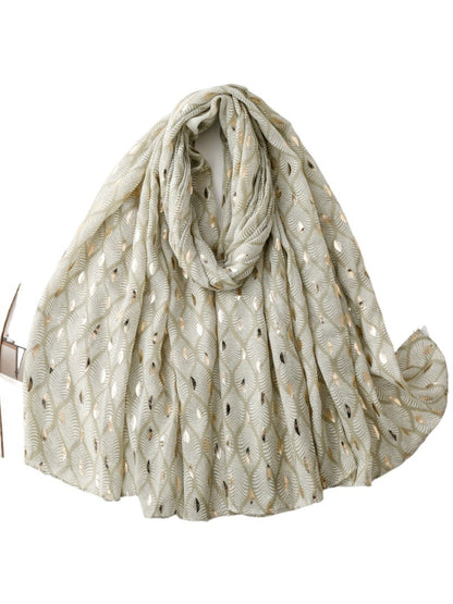 Scarf styled as a head wrap showcasing the feather pattern and soft material