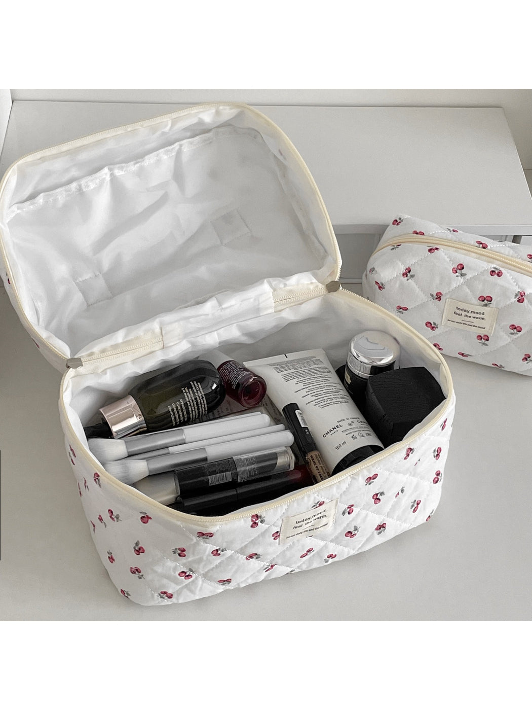 Close-up of cherry pattern and quilted texture on Cosbai travel makeup bag