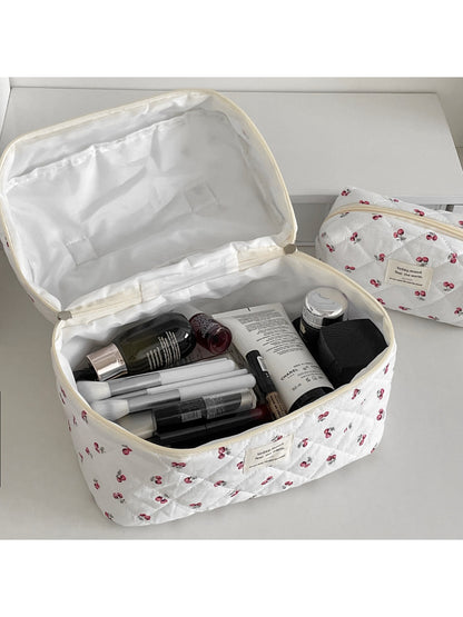 Close-up of cherry pattern and quilted texture on Cosbai travel makeup bag