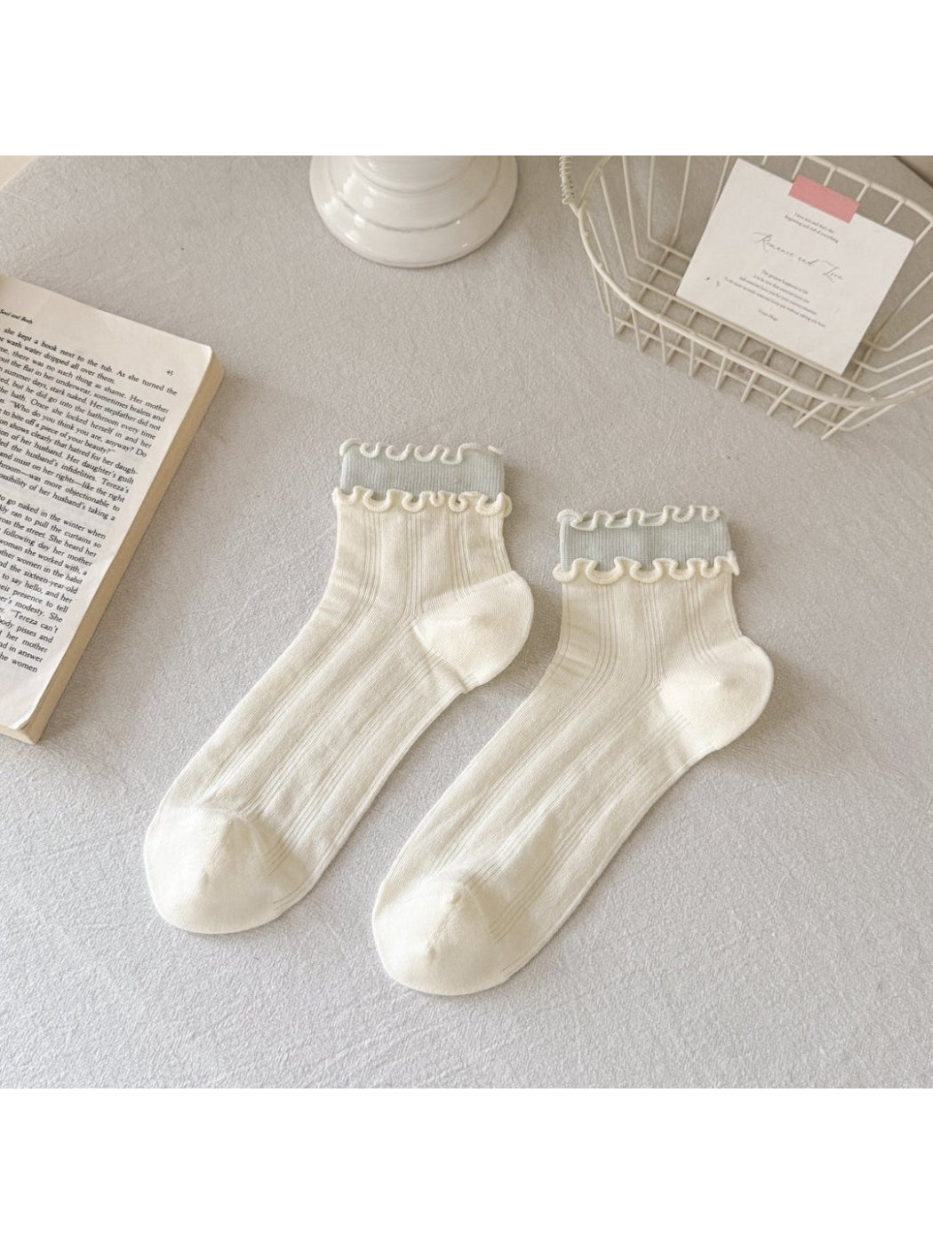 Rufia Sweet Frill Edge Ribbed Socks in pastel blue displayed on wooden surface