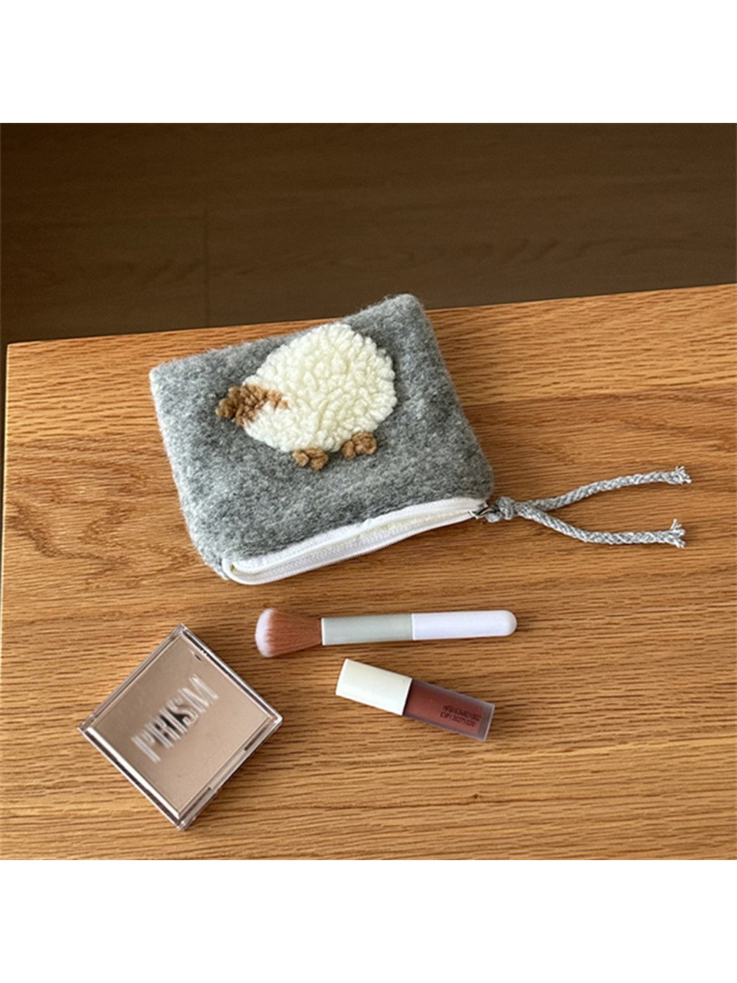Cosbai plush heart pouch photographed with soft shadows on a neutral background
