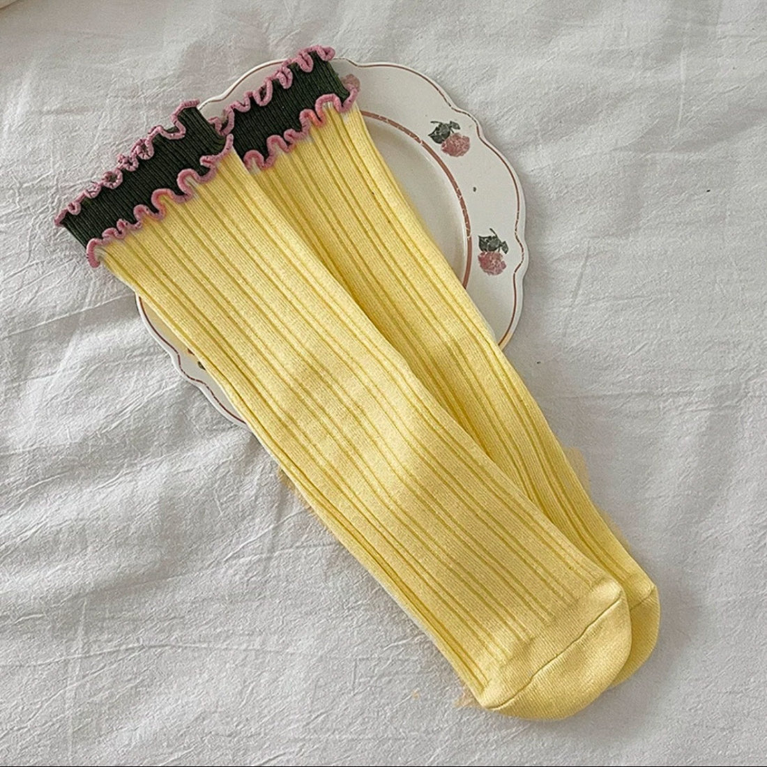 Side view of Rufia long socks highlighting wave trim pattern