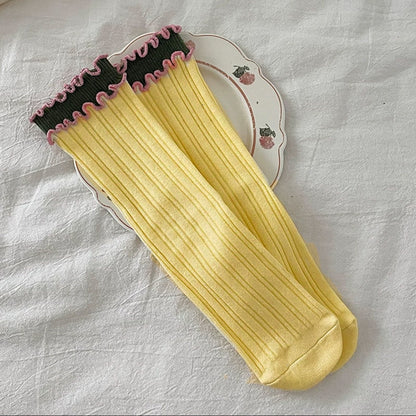 Side view of Rufia long socks highlighting wave trim pattern