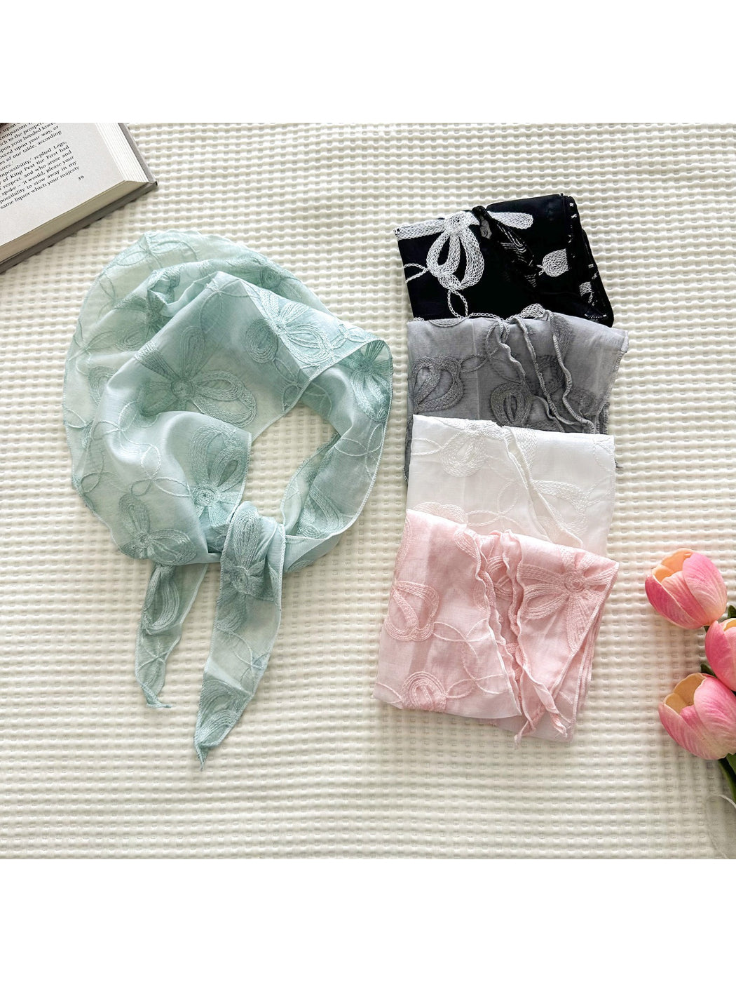 Soft sheer triangle scarf with delicate floral embroidery displayed flat on white background