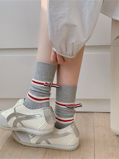 Rufia socks styled with rolled-up pants emphasizing the bold stripe crew length