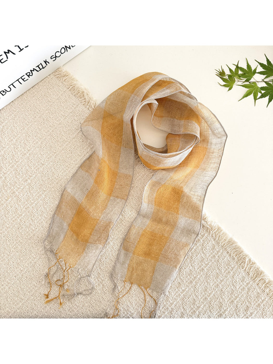 Close-up of soft fabric texture and check pattern on long skinny scarf