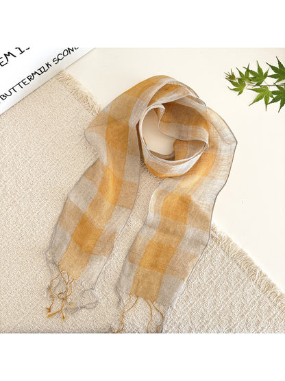 Close-up of soft fabric texture and check pattern on long skinny scarf