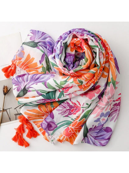 Close-up of Scarvii Tropical Bloom Tassel Scarf fabric with colorful tropical flowers and leaves