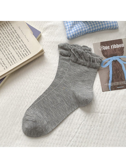 Pair of Rufia crew socks folded to show the frill trim and soft knit
