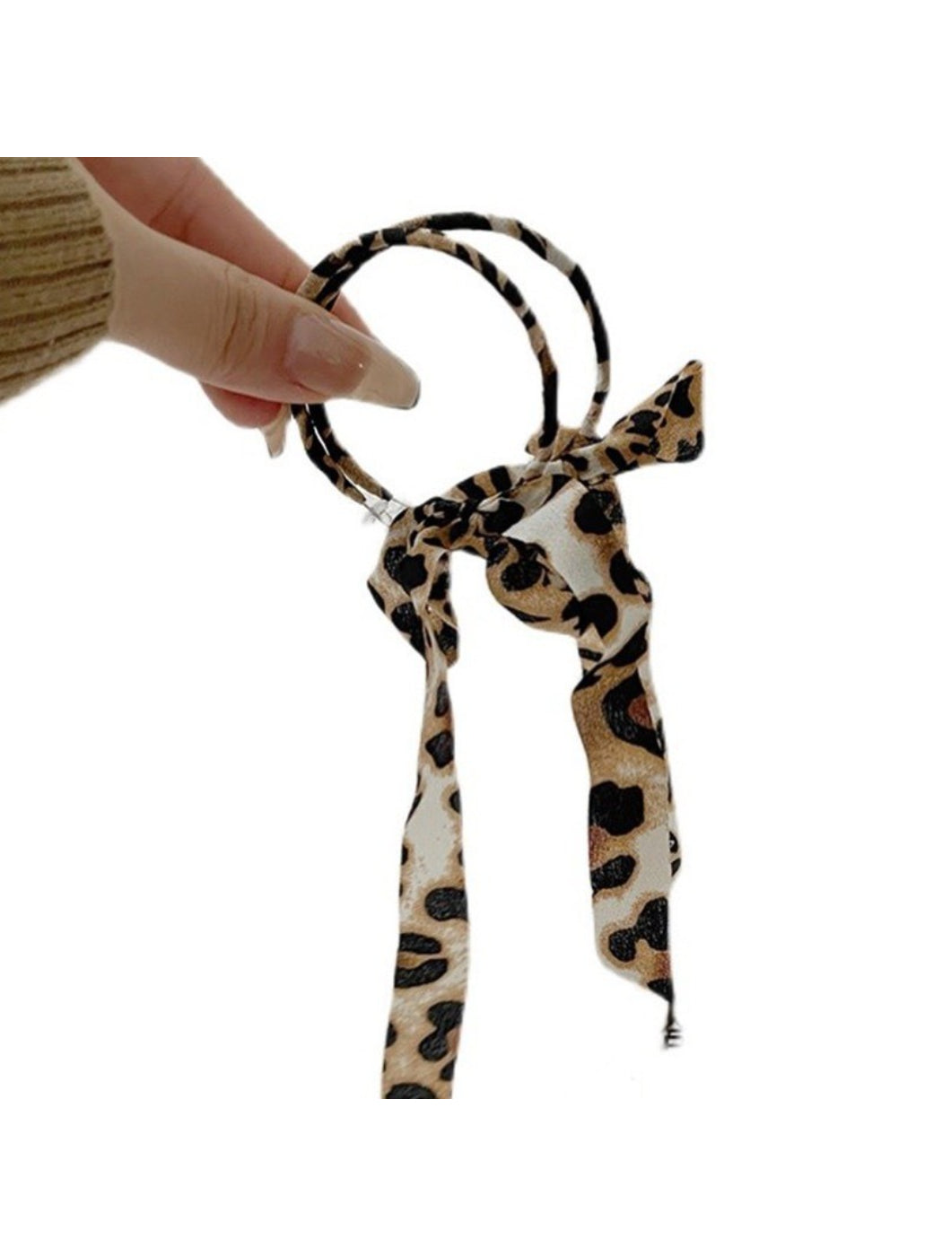 Model wearing Leopard Ribbon Hoop Earrings showcasing size and style with casual outfit