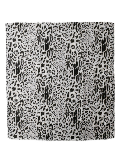 Model wearing snow leopard print scarf draped around neck
