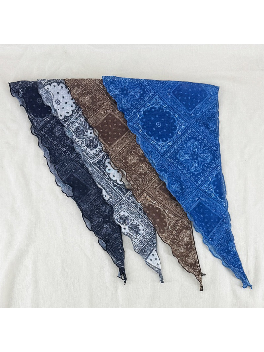 Soft paisley triangle head scarf folded on a white background