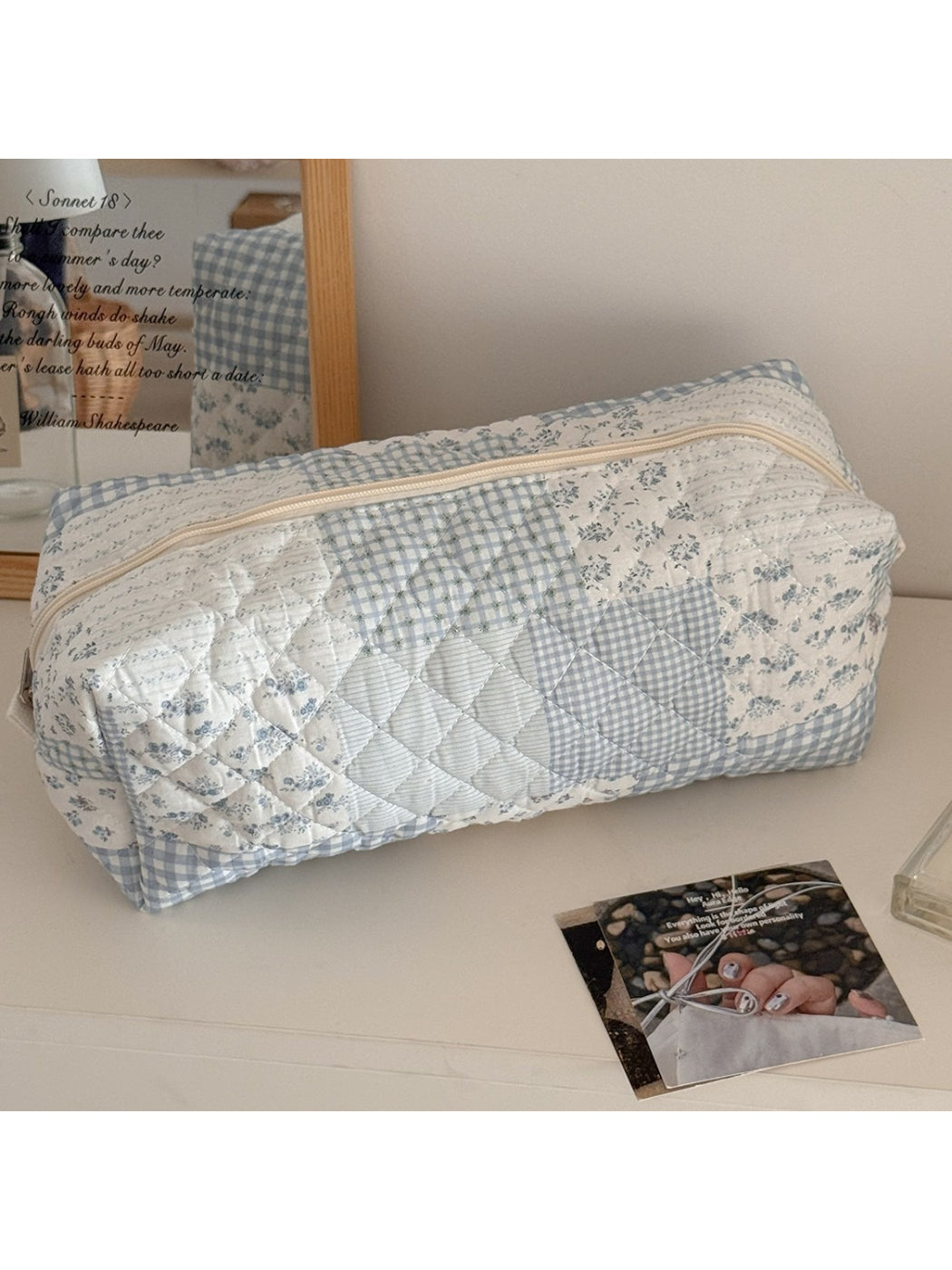 Cosbai vintage flower cosmetic pouch placed on wooden surface with flowers