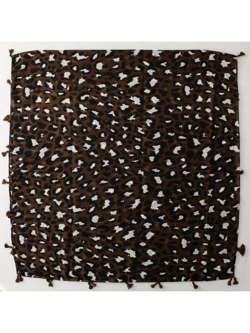 Model wearing brown leopard fringe scarf styled with a black outfit