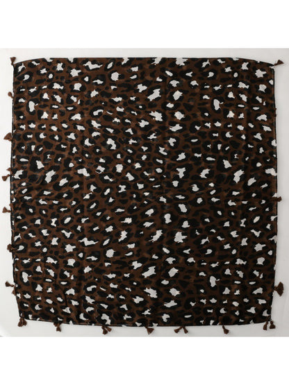 Model wearing brown leopard fringe scarf styled with a black outfit