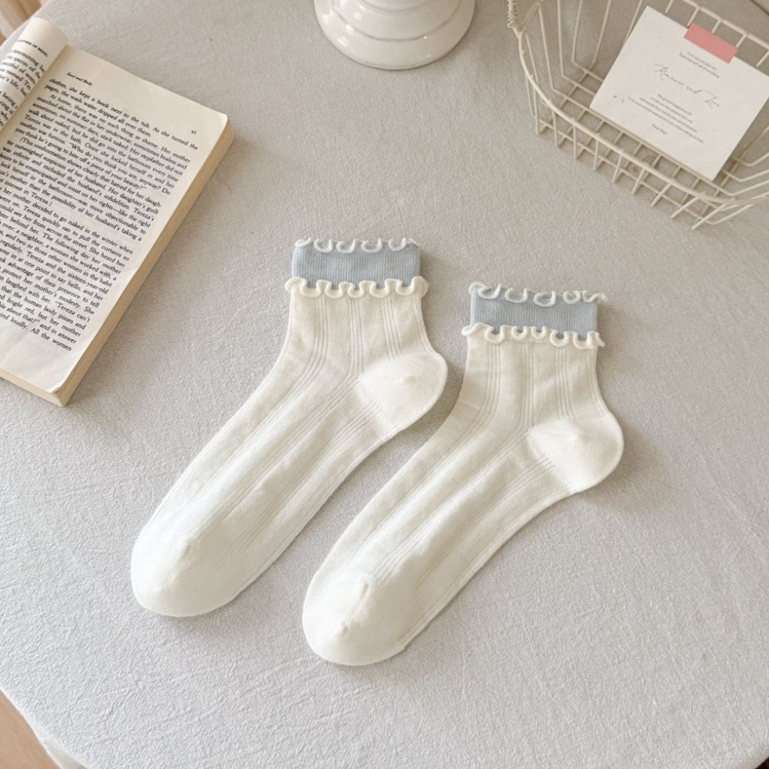 Flat lay of Rufia Sweet Ruffle Edge Crew Socks in pastel pink with ruffle edges