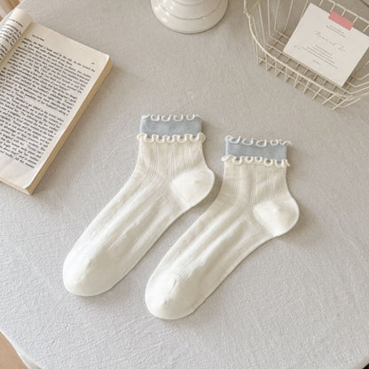 Flat lay of Rufia Sweet Ruffle Edge Crew Socks in pastel pink with ruffle edges