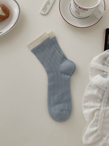Rufia ribbed socks paired with casual outfit on model's feet