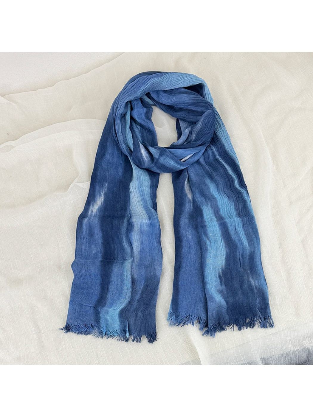 Scarvii Painterly Blue scarf with frayed edges displayed flat on white background