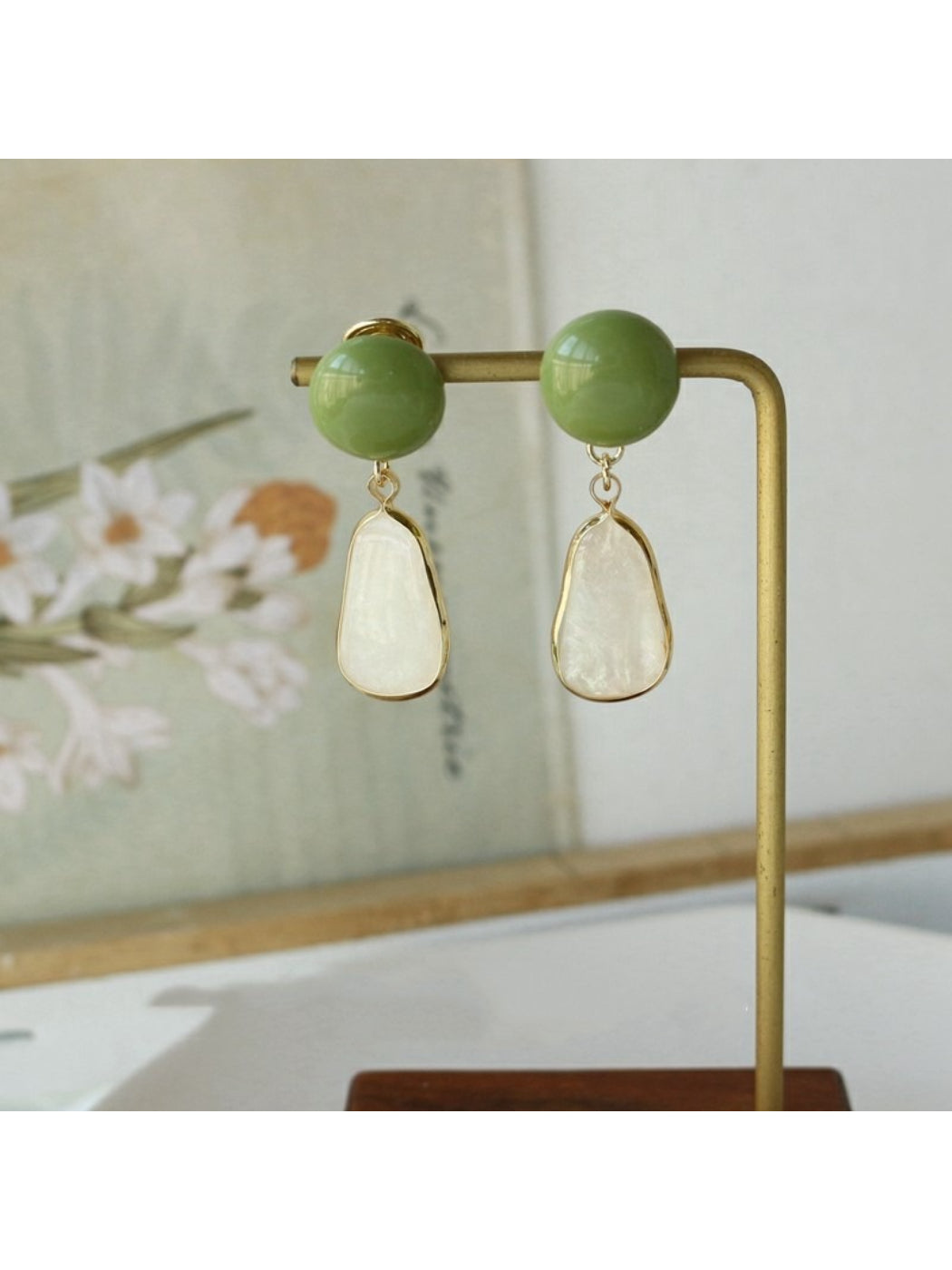 Side view of Earwish Oval Green Top Earrings showing thickness and clasp