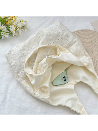 Close-up of detailed white floral embroidery on the Cosbai hobo bag