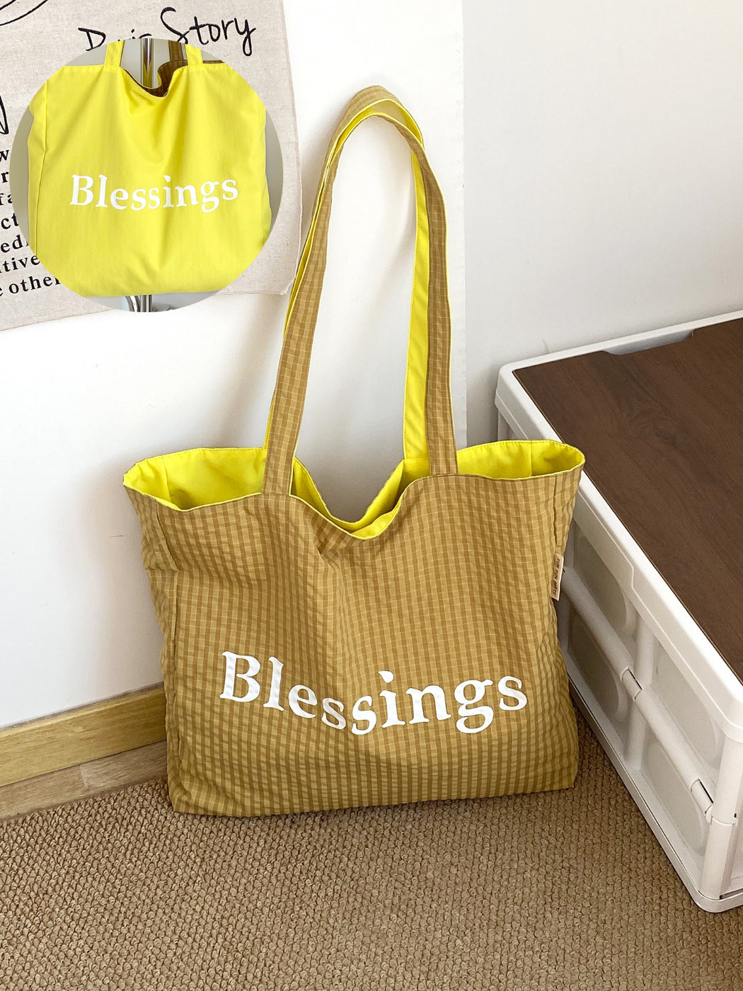 Model holding Cosbai reversible blessings graphic tote bag by handles