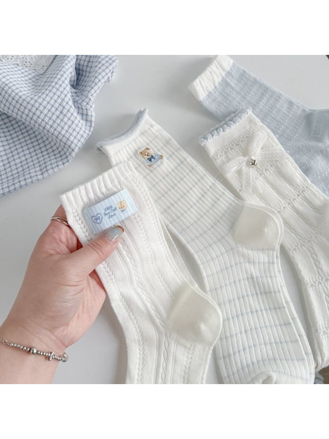 Pair of Rufia Sweet Bear ribbed crew socks in beige with bear face design