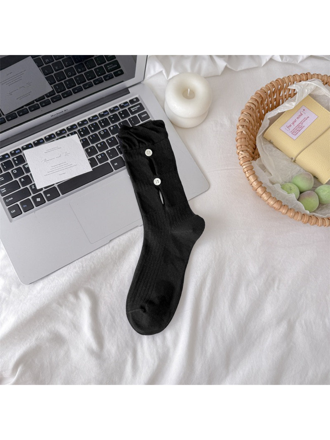 Rufia button cut out crew socks worn on foot, showing fit and design