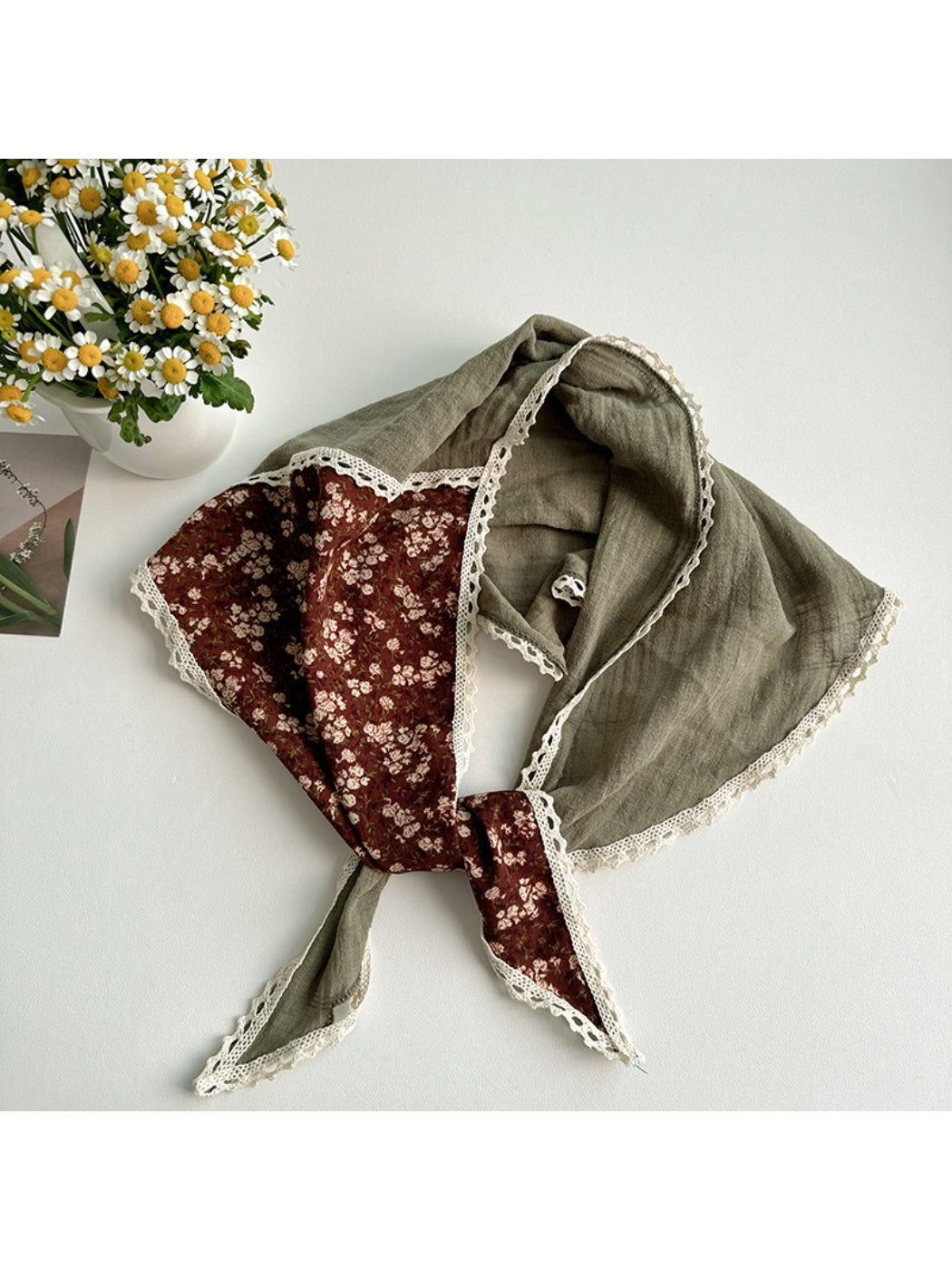 Close-up of Scarvii triangle scarf highlighting detailed floral patchwork and delicate lace edges