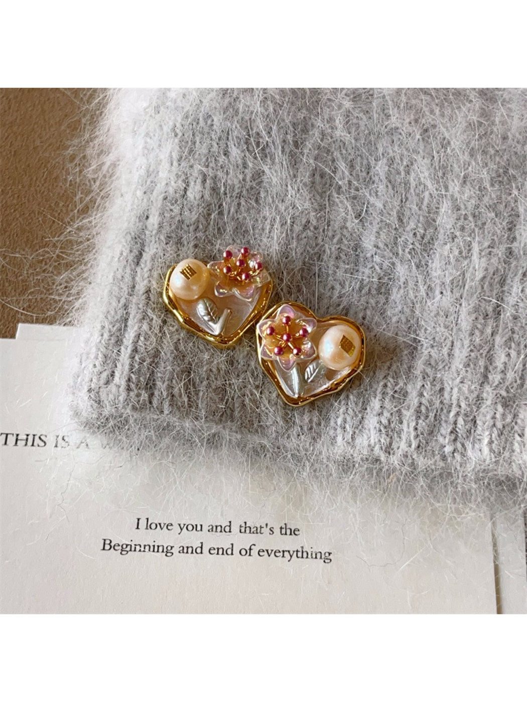 Detailed view of the floral heart design and metal finish on Earwish earrings