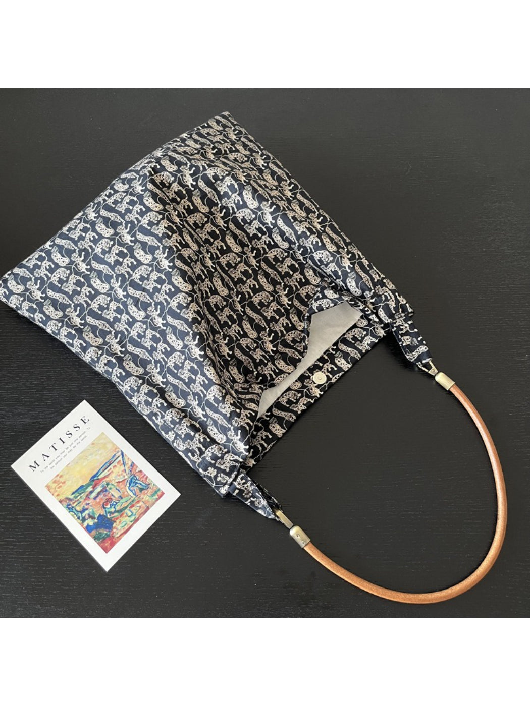 Cosbai black shoulder bag displayed on white background with black cat print