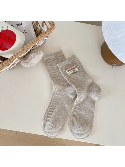 Side view of Rufia casual neutral crew socks highlighting fabric stretch